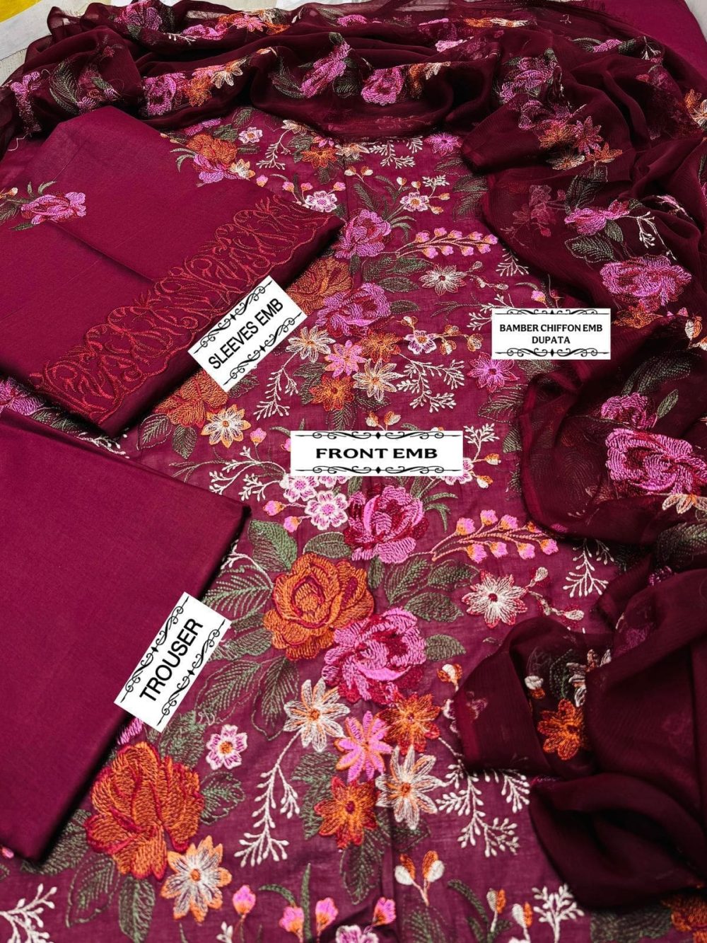 Flat lay of Bareeze maroon embroidered lawn suit showing floral embroidered front, embroidered sleeves, chiffon dupatta, and dyed trouser