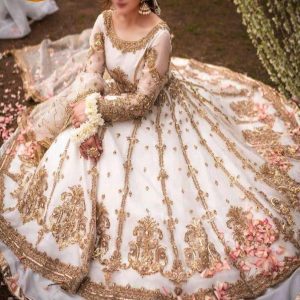Bride wearing ivory maxi with heavy golden embroidery and floral details